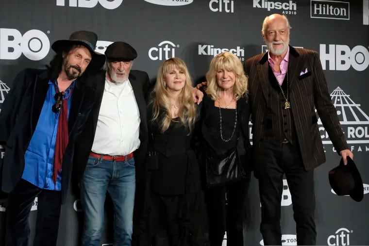 FILE - This March 29, 2019, file photo shows Inductee Stevie Nicks (center) posing with other members of Fleetwood Mac (from left) Mike Campbell, John McVie, Christine McVie, and Mick Fleetwood at the Rock & Roll Hall of Fame induction ceremony in New York. Illness is forcing Fleetwood Mac to cancel a number of appearances including its upcoming Jazz Fest performance, where the band was a last-minute replacement for the Rolling Stones. The New Orleans Jazz & Heritage Festival says on Twitter that Fleetwood Mac is postponing four upcoming North American tour dates and the May 2 Jazz Fest performance due to Nicks’ illness. (Photo by Charles Sykes / Invision / AP, File)
