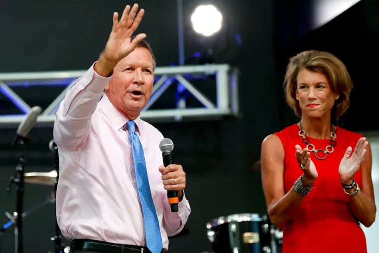 John Kasich, with his wife, Karen, speaks at the Rock and Roll Hall of Fame in Cleveland. He has angered the Trump camp by declining to endorse the Republican nominee.