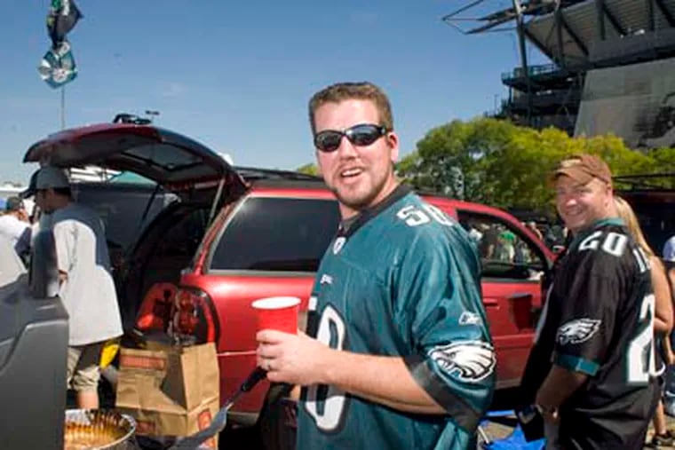 In the parking lot across from Lincoln Financial Field, Eagles fan Brian Niwinski, 32, of Doylestown thinks he pays enough for the sports experience and shouldn't be taxed more.       (Ed Hille / Staff Photographer)
