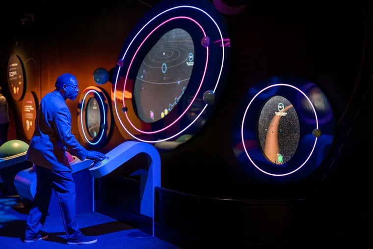 Franklin Institute chief astronomer Derrick Pitts tries out an interactive display during a preview of "Wondrous Space" on Thursday, Nov. 2, 2023. "Wondrous Space" is the museum’s new permanent exhibit about space exploration.