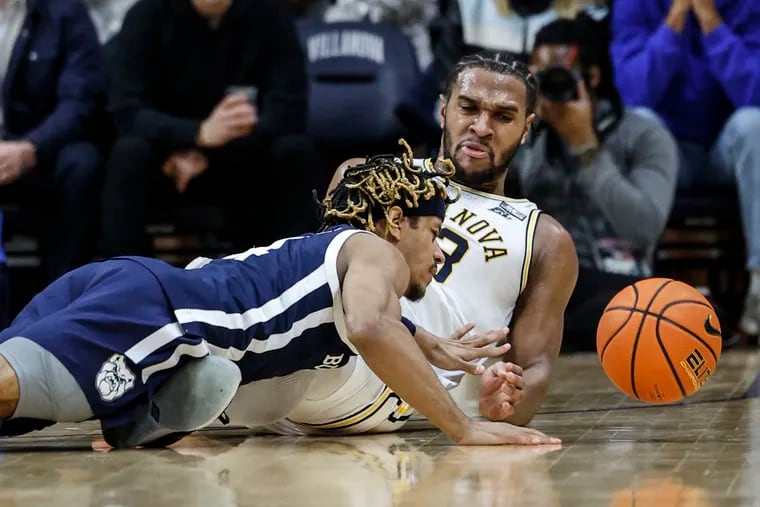 Villanova's Eric Dixon battles Butler's DJ Davis for a loose ball during the second half Tuesday at Finneran Pavilion. Defense and rebounding have been the calling cards of the Wildcats' recent hot streak.