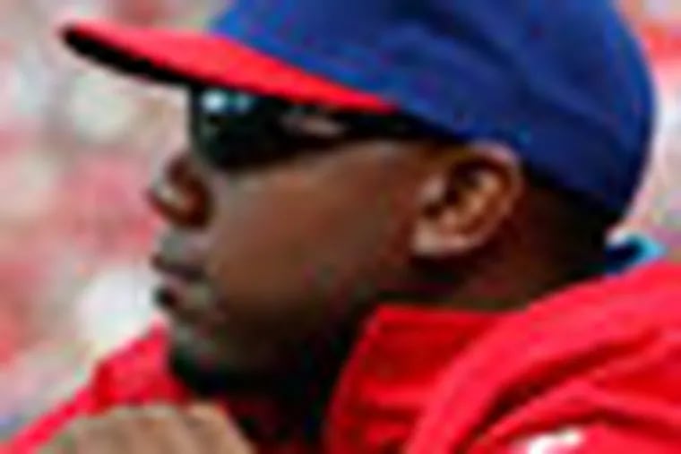 Phillies' Ryan Howard, left, and manager Charlie Manuel, right, watch from the dugout in the 7th inning. Phillies lose 6-2 to the Miami Marlins at Citizens Bank Park in Philadelphia, Pa. on April 9, 2012.  ( David Maialetti  / Staff Photographer )