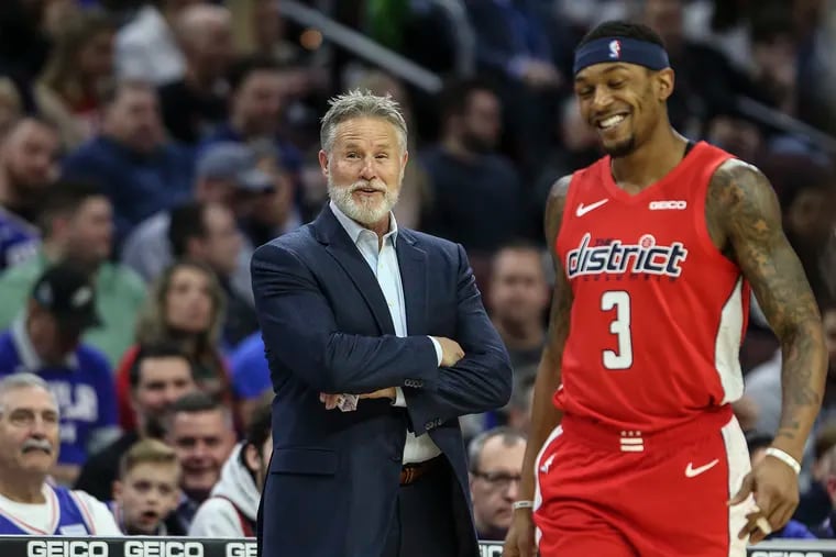 Sixers' head coach Brett Brown shares a word with  Wizards' Bradley Beal during the 1st quarter at the Wells Fargo Center in Philadelphia, Tuesday, January 8, 2019. Sixers beat the Wizards 132-115.  STEVEN M. FALK / Staff Photographer