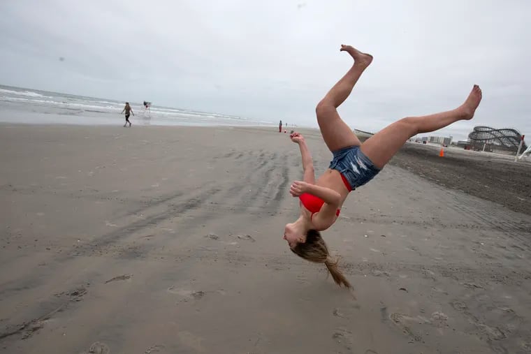 Cecilia Dalfonso of Glassboro, NJ does a flip on the beach in Wildwood, NJ on May 25, 2020. A gray windy morning would later turn into a perfect sunny day.
