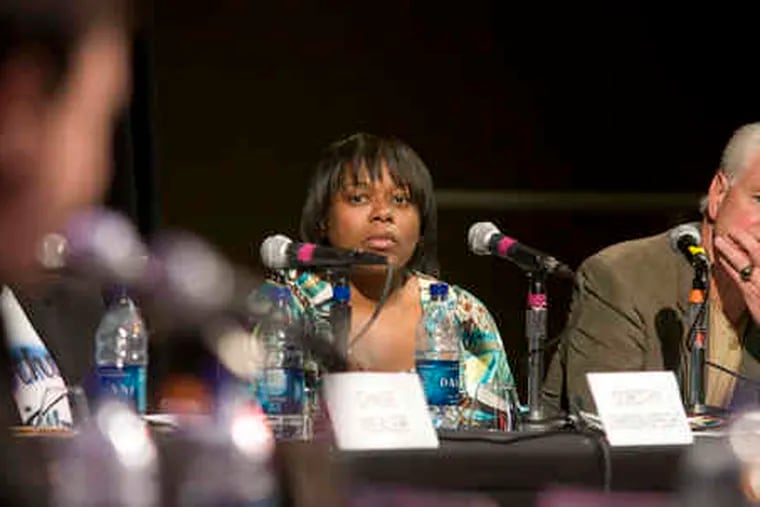 During the district attorney debate, survivor panelists Kim Hartsfield-Stokes and Larry McDonald listen to candidates' comments.