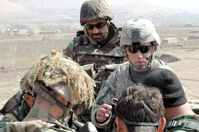 Lt. Eric Schwirian (right, wearing sunglasses) talks to his men before they begin a mission. Schwirian, a recent graduate of Drexel University, describes leading men in combat as “the greatest feeling in the world.”