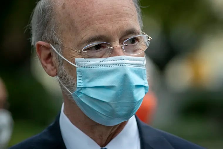 Pennsylvania Governor Tom Wolf with his face mask at a press conference outside the Bucks County Justice Center in Doylestown in September.  “No one is immune from COVID. Following all precautions as I have done is not a guarantee," he said when he tested positive.