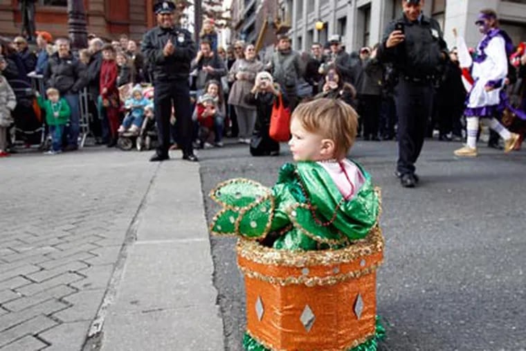 Sixteen-month-old Sophia Salerno, of Center City, receives attention from the crowd near the Union League during the New Year's Day parade in Philadelphia on January 1, 2012. ( David Maialetti  / Staff Photographer )