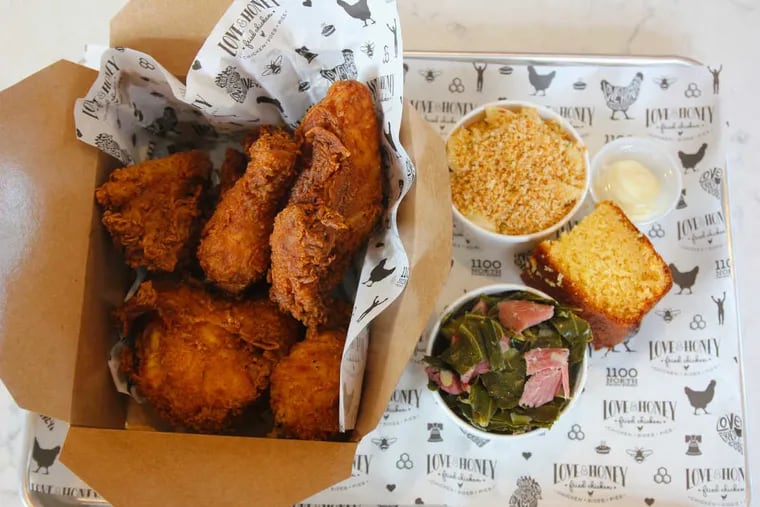 Chicken, plus shells and cheese, cornbread, and collard greens with smoked turkey, at Love &amp; Honey Fried Chicken, 1100 N. Front St.