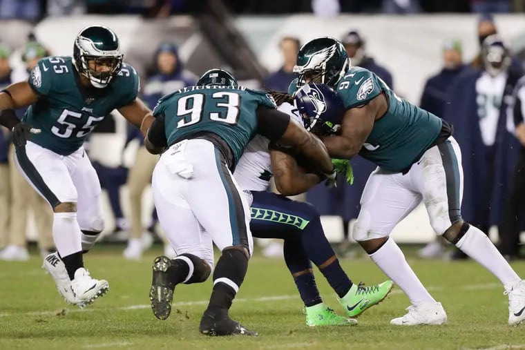 Eagles defensive linemen Fletcher Cox, Timmy Jernigan and Brandon Graham going after Seattle Seahawks running back Marshawn Lynch in the NFC wild-card playoff game back on Jan. 5 at Lincoln Financial Field.