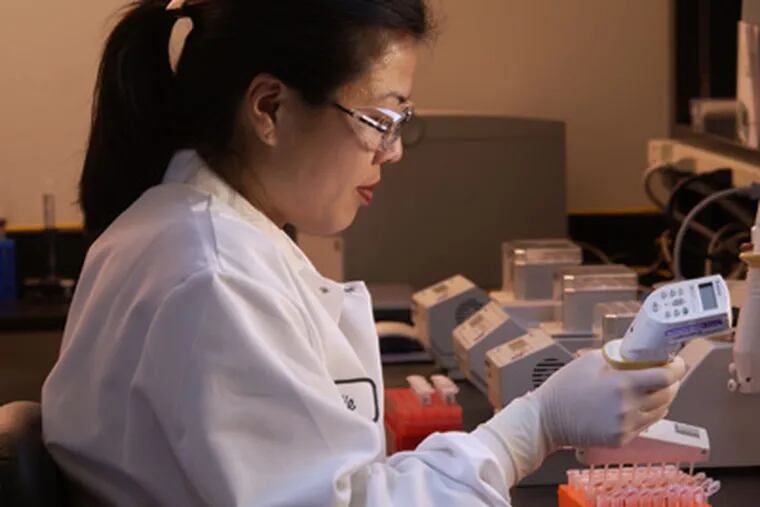 A scientist at Genomic Health prepares samples for testing that will yield a score indicating the risk of breast-cancer recurrence.