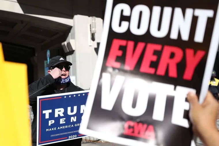 A Trump supporter faces off against “Count Every Vote” protesters outside the building where Philadelphia elections officials were counting votes in November 2020. Almost a year later, Pennsylvania Republican lawmakers are pursuing a partisan investigation of the election.