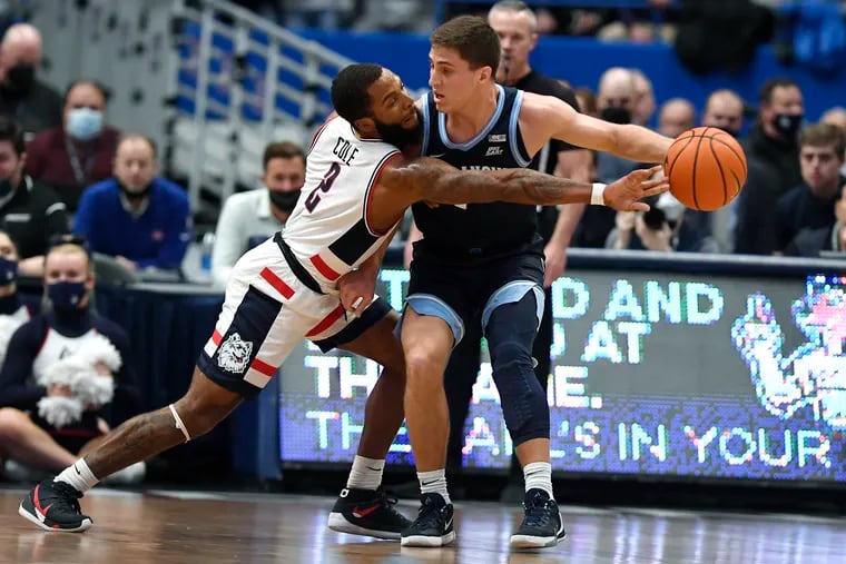 Connecticut's R.J. Cole knocks the ball away from Villanova's Collin Gillespie during the first half in Hartford, Conn.