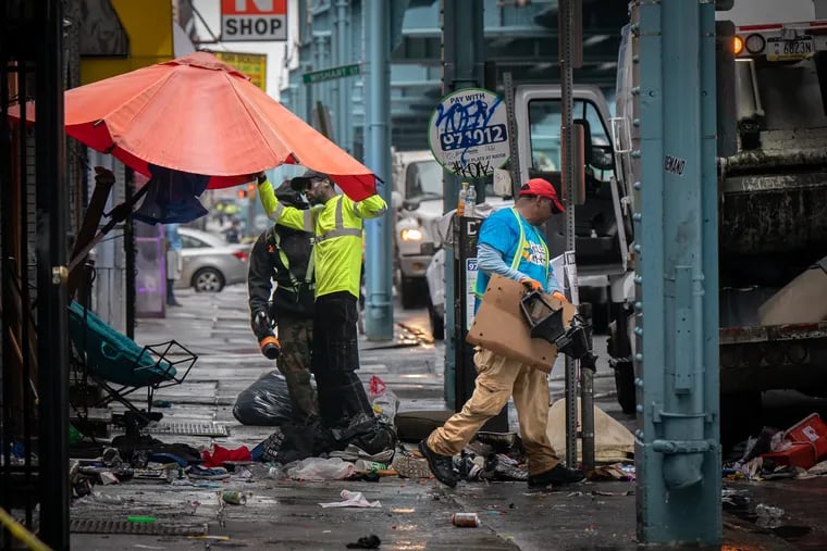 Workers remove debris from the encampment on Kensington Avenue last week. The Parker administration defended the operation over the weekend, saying advocates interrupted the process.