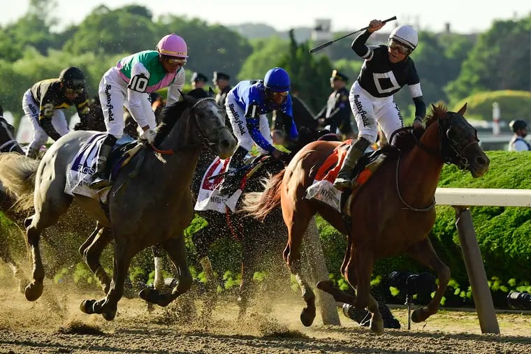 Jockey Joel Rosario, atop Sir Winston (7), right, reacts as after crossing the finish line ahead of Tacitus (10), with jockey Jose Ortiz up, to win the 151st running of the Belmont Stakes horse race, Saturday, June 8, 2019, in Elmont, N.Y. (AP Photo/Steven Ryan)