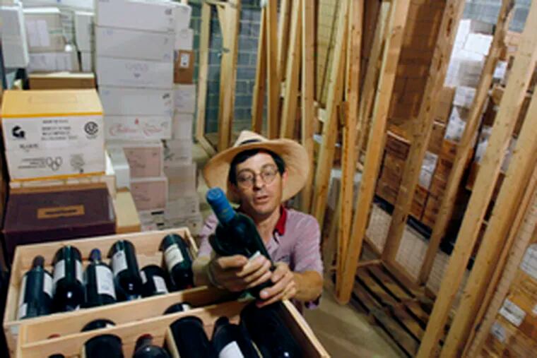 Scot H. Ziskind examines a bottle of Chateau Montrose in his temperature-controlled wine-storage facility on the fringes of Pennsauken. He stores more than 144,000 bottles commercially.