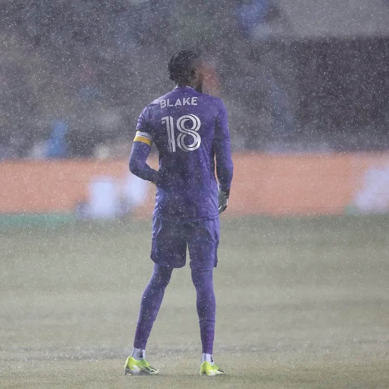 Andre Blake standing in the rain before the Union-Sounders game was postponed because of a waterlogged field.