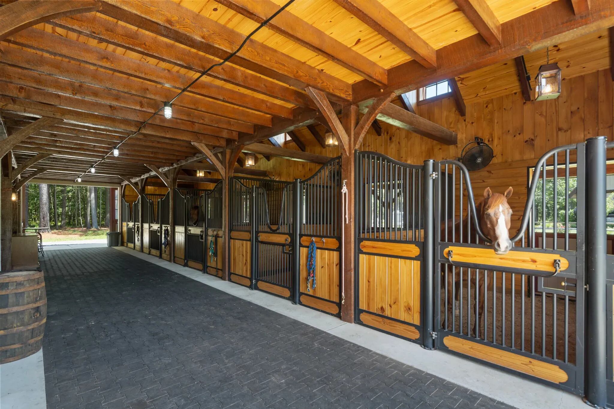 All five modular horse stalls in the Amish-built barn are equipped with fans, cameras for monitoring, and rubber mats. The barn also has a tack room with lockers, a wash stall, a kitchenette and a guest suite with a full bathroom.