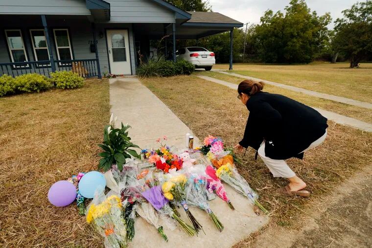 Anastasia Gonzalez of Burleson, Texas leaves a flowers on the front sidewalk of Atatiana Jefferson's home on E. Allen Ave on Oct. 15, 2019 in Fort Worth. In the wake of Fort Worth officer Aaron Dean shooting and killing Jefferson in her home, people have been leaving flowers at a memorial.