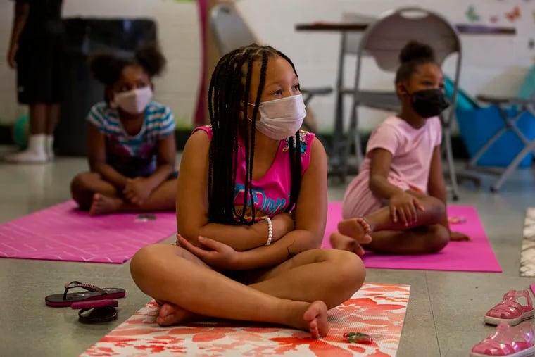Sasha Richardson, 8, sits in a summer camp class about the book, “I Am Rosa Parks” by Brad Meltzer, at Martin Luther King Jr. Recreation Center in North Philadelphia. She said she's disappointed because COVID-19 prevents the kids from playing tag.