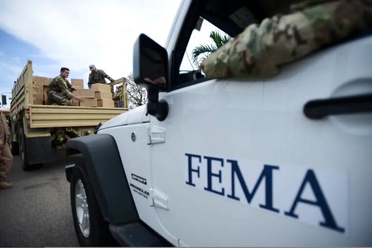 FILE - In this Oct. 5, 2017 file photo, Department of Homeland Security personnel deliver supplies to Santa Ana community residents in the aftermath of Hurricane Maria in Guayama, Puerto Rico. A government watchdog has found the Federal Emergency Management Agency wrongly released to a contractor the personal information of 2.3 million survivors of hurricanes Harvey, Irma and Maria and the California wildfires in 2017.