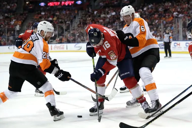 The Flyers' Claude Giroux (28) and Travis Sandheim team up to stop Florida's Aleksander Barkov (16) in the first period.