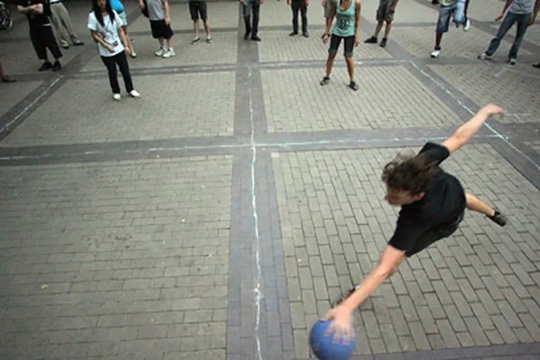 Dallas Conrad, 21, of Philadelphia, plays four square in Rittenhouse Square, where the game was a Monday-night summer ritual for three years. (David Swanson / Staff Photographer)