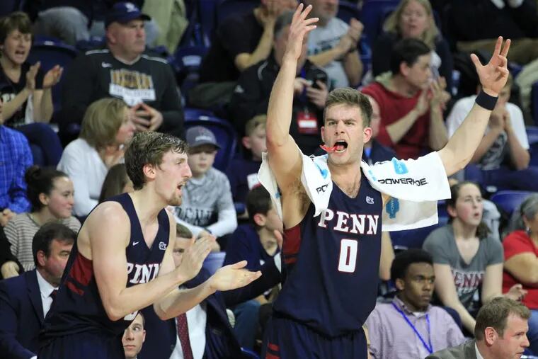 Caleb Wood, left, and Max Rothschild of Penn urge on the fans during their game against Harvard in the 2nd half of an Ivy League game at the Palestra on Feb. 24, 2018.