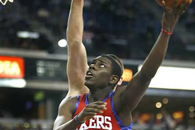 Jrue Holiday drives to the basket past Sacramento Kings defender Spencer Hawes during the first half of last night's game. (AP Photo/Steve Yeater)