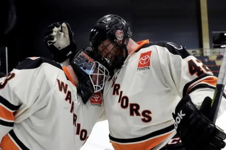 Ian Woods (left), a Coast Guard veteran, and former Marine Tim Wynn celebrate after a big moment with the Warriors hockey team, which is composed of military vets with disabilities.