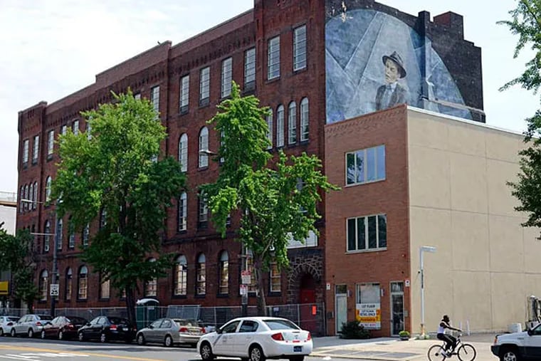 The old Third Regiment Armory on South Broad Street, with its Frank Sinatra mural, will be torn down to make room for a six-story apartment building with environmentally friendly features. (Tom Gralish/Staff)