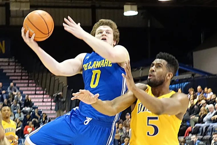 Delaware’s Ryan Daly is fouled by Drexel’s Austin Williams going to the basket