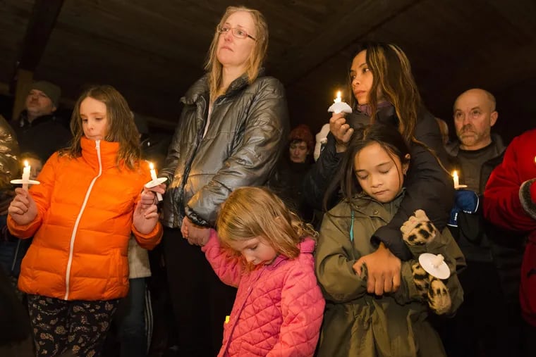 Erin, Julie and Miriam Rebbechi (left to right), Zahara Shapiro (top)  and daughter Aliyah Shapiro at a Tuesday night vigil in Paddock Park for a toddler struck and killed at a nearby YMCA parking lot.