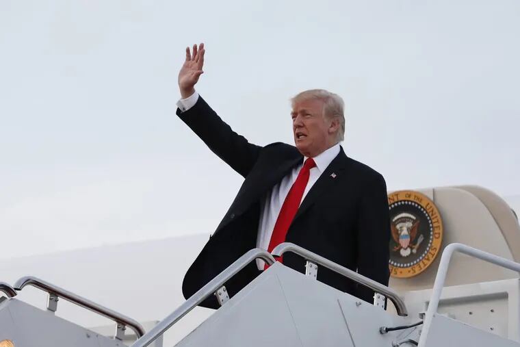 President Trump waves as he arrives on Air Force One, Monday, at Andrews Air Force Base in Maryland.
