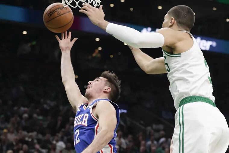 Sixers guard T.J. McConnell tries to shot over Boston Celtics forward Jayson Tatum during the second-quarter on Tuesday, October 16, 2018 in Boston.