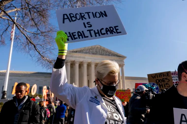 Abortion rights advocates and anti-abortion protesters demonstrate in front of the U.S. Supreme Court Dec. 1 as the justices hear arguments in a case from Mississippi that could lead the court to overturn the landmark 1973 Roe v. Wade decision.