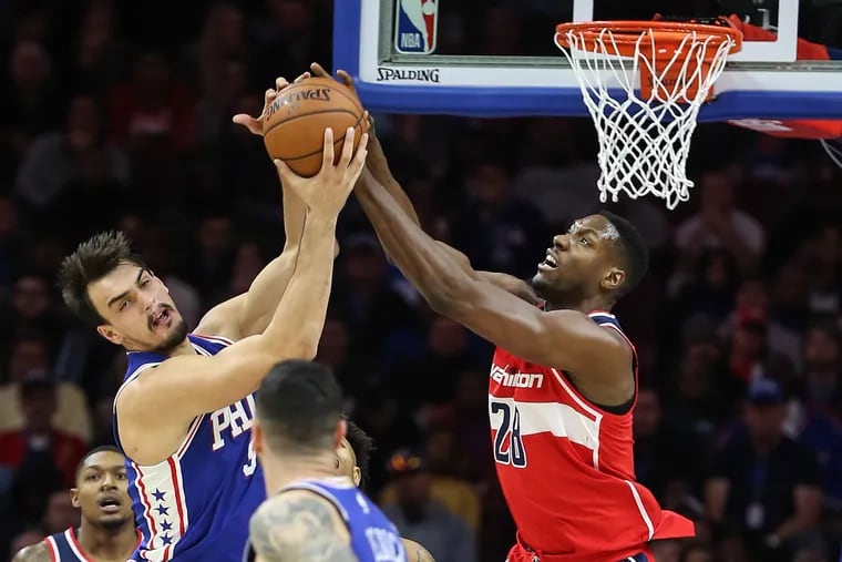 Dario Saric battling for a rebound with the Wizards' Ian Mahinmi in November. 