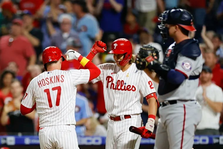Rhys Hoskins celebrates his fourth-inning solo home run with teammate Alec Bohm on Friday.