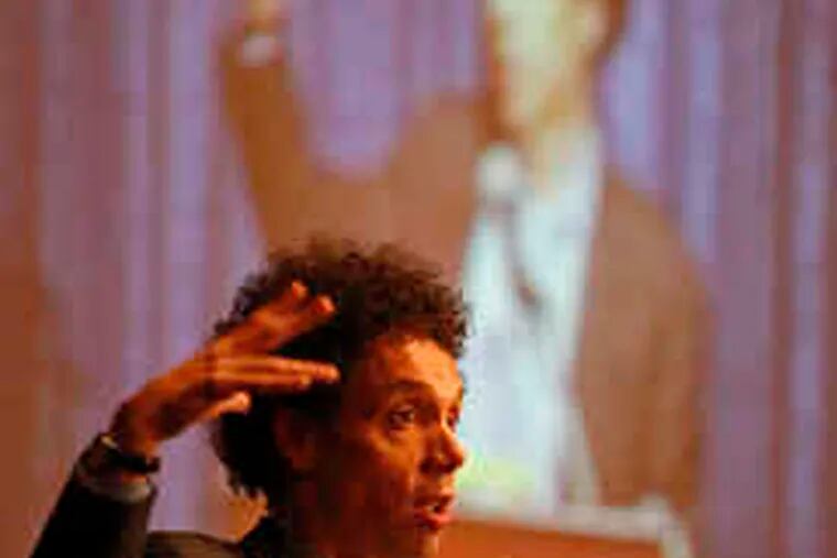 Malcolm Gladwell gestures during his speech to Leadership Philadelphia at the Union League. &quot;The question of how much we want to achieve in a certain area is up to us,&quot; he said.