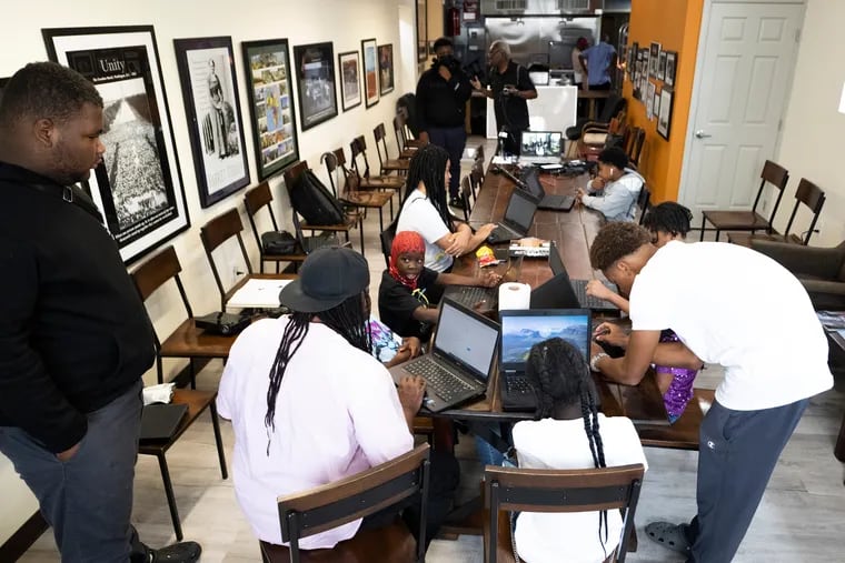 Kids take part in a computer class Monday during a summer program at the Strawberry Learning  Center. Students will keep up with reading skills  at this summer program in Strawberry Mansion. The learning center used to be a corner bar.