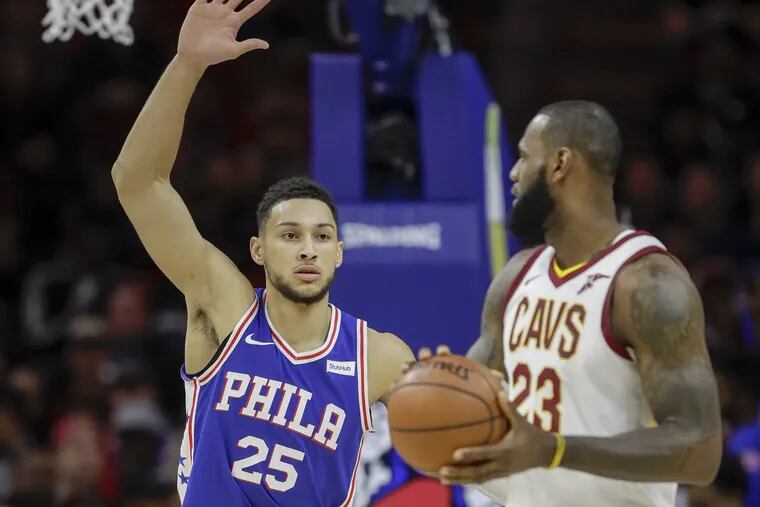 Sixers guard Ben Simmons defends Cleveland Cavaliers forward LeBron James during the first quarter.