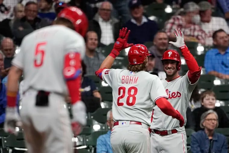 Philadelphia Phillies' Alec Bohm (28) is congratulated by Matt Vierling after hitting a game-tying home run against the Milwaukee Brewers during the ninth inning of a baseball game Tuesday, June 7, 2022, in Milwaukee. (AP Photo/Aaron Gash)