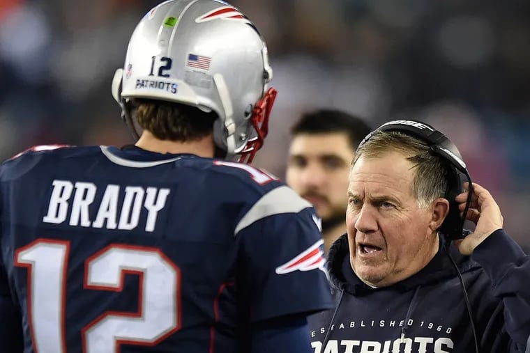 Patriots coach Bill Belichick confers with quarterback Tom Brady.