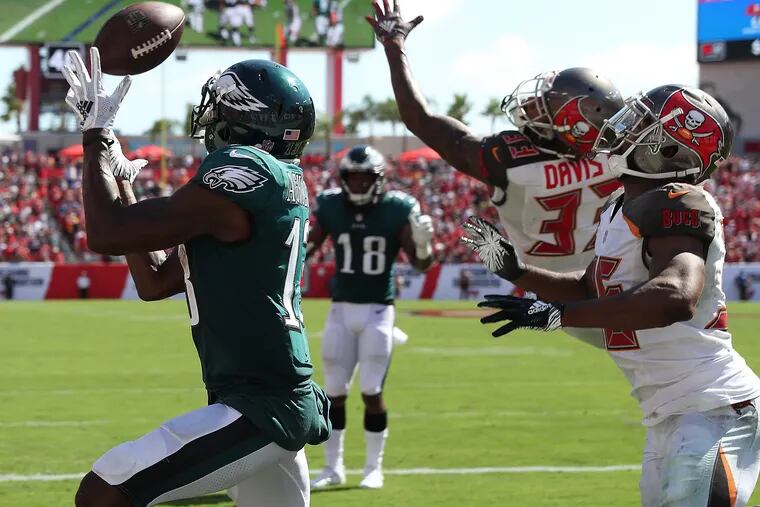 Eagles' Nelson Nelson Agholor, left, catches a touchdown pass in the Philadelphia Eagles 27-21 loss to the Tampa Bay Buccaneers in Tampa, Fl on September 16, 2018. DAVID MAIALETTI / Staff Photographer