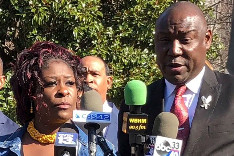 April Pipkins and her family's lawyer, Ben Crump, hold a news conference in Birmingham, Ala., on Monday, Dec. 17, 2018. Pipkins, the mother of a black man who was shot to death by a police officer in an Alabama shopping mall on Thanksgiving, criticized the state's decision to take over an investigation of the case. Emantic "EJ" Bradford Jr. was fatally wounded after an officer saw him with a gun, authorities said. (AP Photo/Jay Reeves)