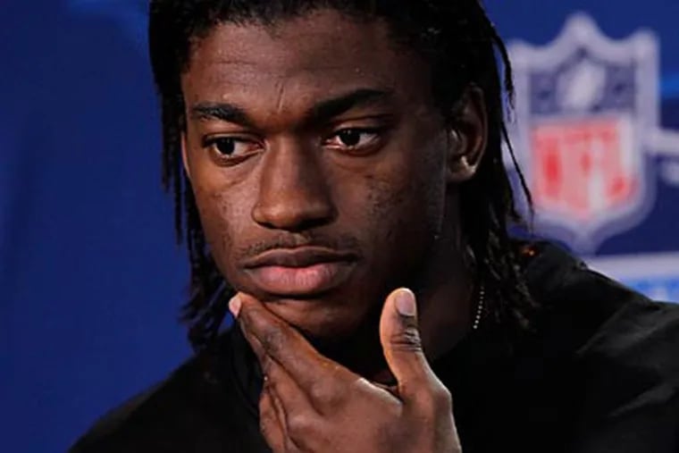 Quarterback Robert Griffin III, who won the Heisman Trophy, can run and throw equally well. (Michael Conroy/AP)