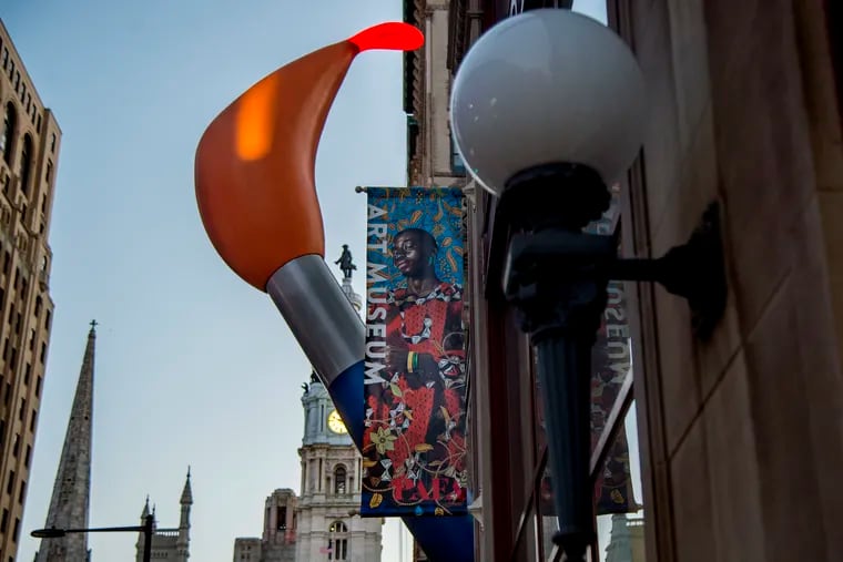 A portion of sculpture Paint Torch (2011) by Claes Oldenburg is seen next to the contemporary Samuel M.V. Hamilton Building at the Pennsylvania Academy of the Fine Arts (PAFA).