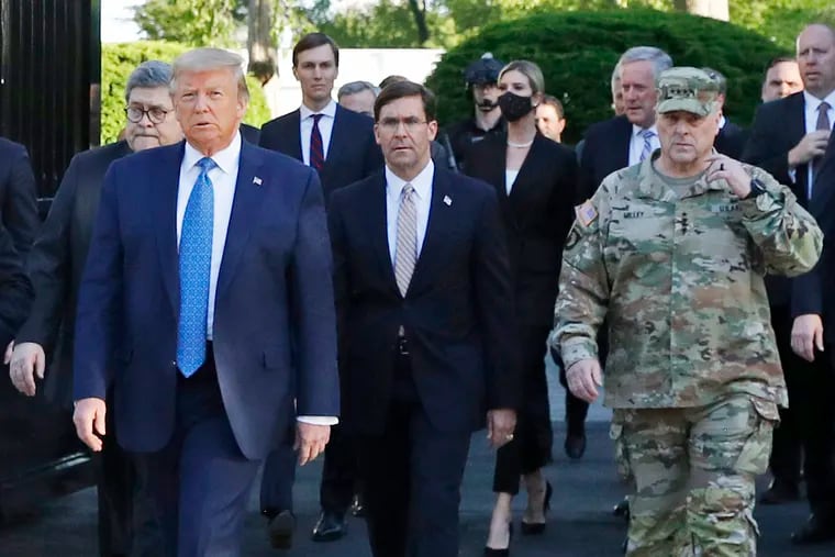 President Donald Trump departs the White House to visit outside St. John's Church, in Washington. Part of the church was set on fire during protests on Sunday night. Walking behind Trump from left are, Attorney General William Barr, Secretary of Defense Mark Esper and Gen. Mark Milley, chairman of the Joint Chiefs of Staff.  Milley says his presence “created a perception of the military involved in domestic politics.” He called it “a mistake” that he has learned from.  (AP Photo/Patrick Semansky)