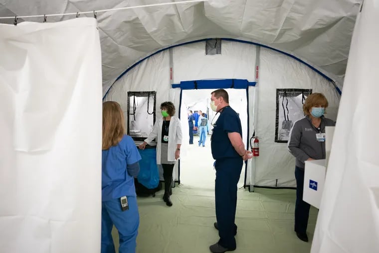 Medical staff inside the new emergency response tent during a media tour of the facility at Doylestown hospital, the emergency response tent will centralize diagnosis and initial treatment for those with respiratory symptoms suggesting COVID-19, in Doylestown, PA, March 30, 2020.