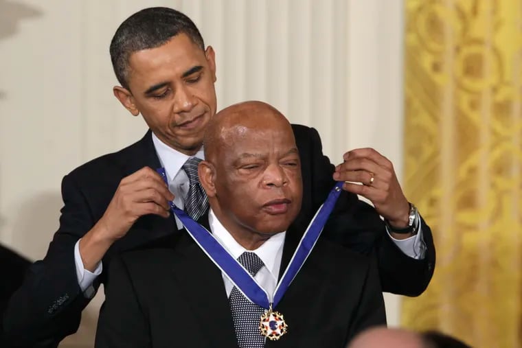 FILE - In this Feb. 15, 2011, file photo, President Barack Obama presents a 2010 Presidential Medal of Freedom to Rep. John Lewis (D., Ga.) during a ceremony in the East Room of the White House in Washington. Lewis announced Sunday, Dec. 29, 2019, that he has stage IV pancreatic cancer, vowing he will stay in office and fight the disease with the tenacity which he fought racial discrimination and other inequalities since the civil rights era. (AP Photo/Carolyn Kaster, File)